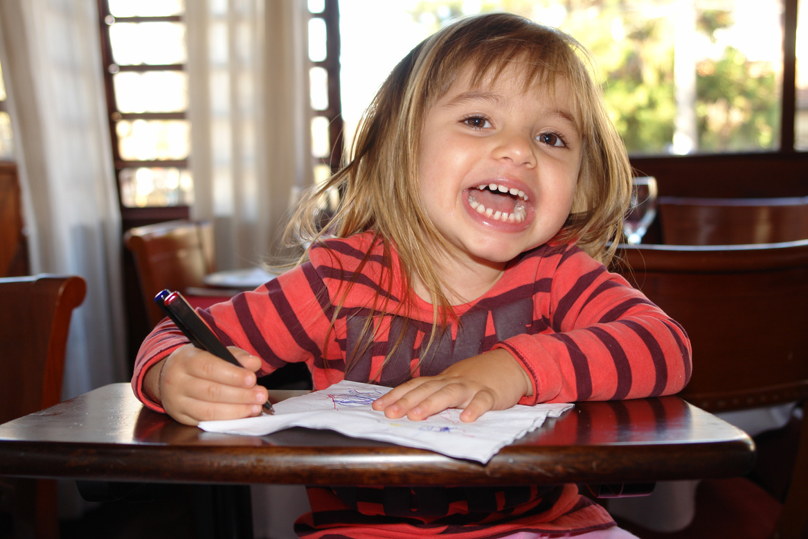 Child 2-3 years old draws smiles and very happy